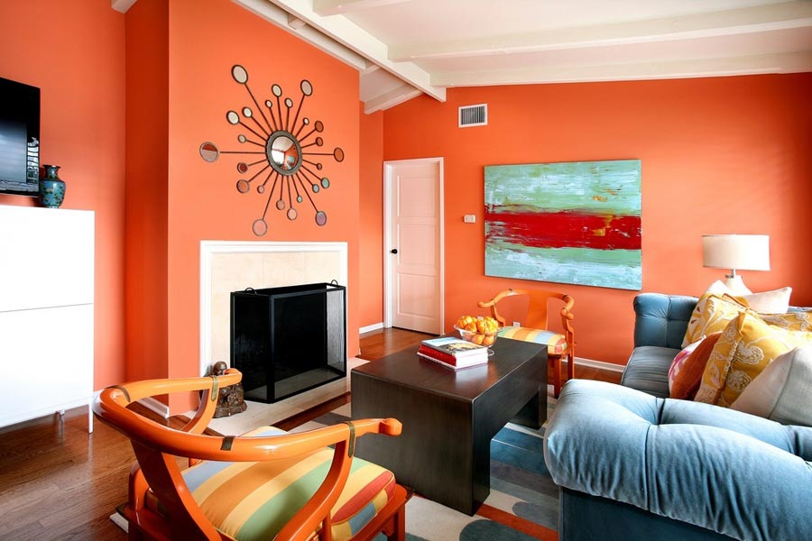 Brightly painted walls in the living room with a blue sofa