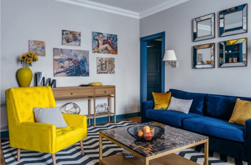 Blue sofa in the hall with a yellow armchair