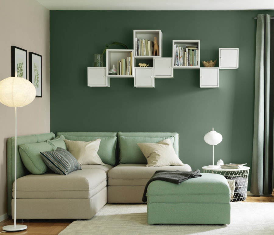 White shelves on a green living room wall