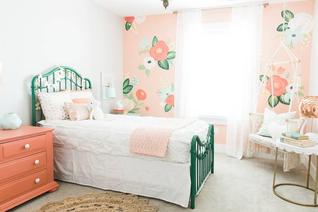 Green bed in the white bedroom of the girl