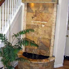 Outdoor waterfall near the stairs in a private house