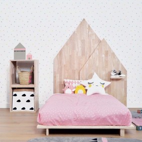 Children's bed with wooden headboard