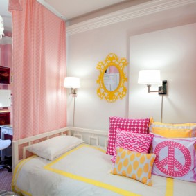 Bright pillows on the bed of the girl