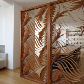 Openwork veneer screen in the living room of a country house