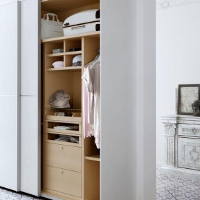 White wardrobe with chipboard shelves