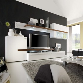 White cabinet furniture near the black wall