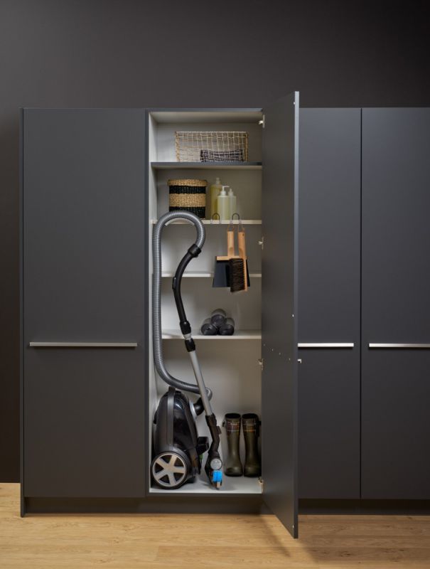 Vacuum cleaner storage in a utility cabinet