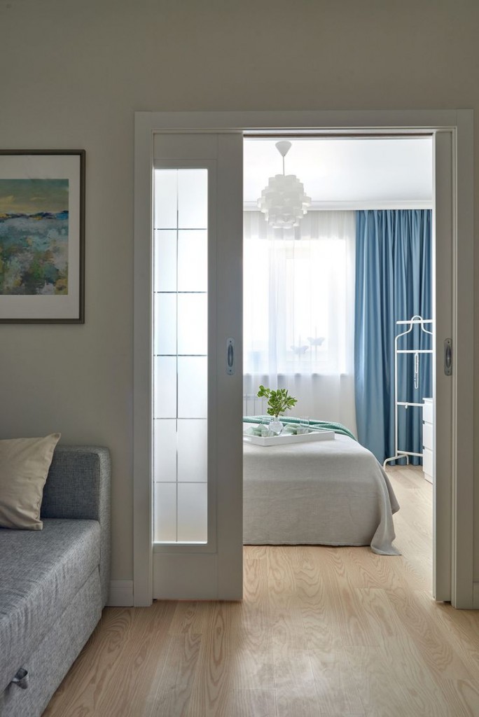 White sliding door between bedroom and living room