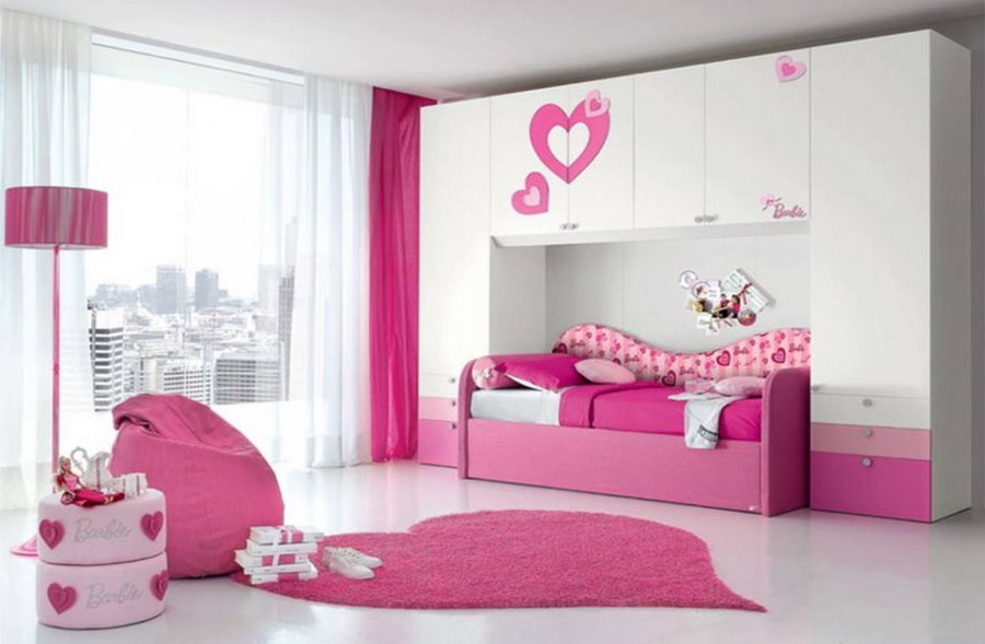 Pink bed in the bedroom of a school-age girl
